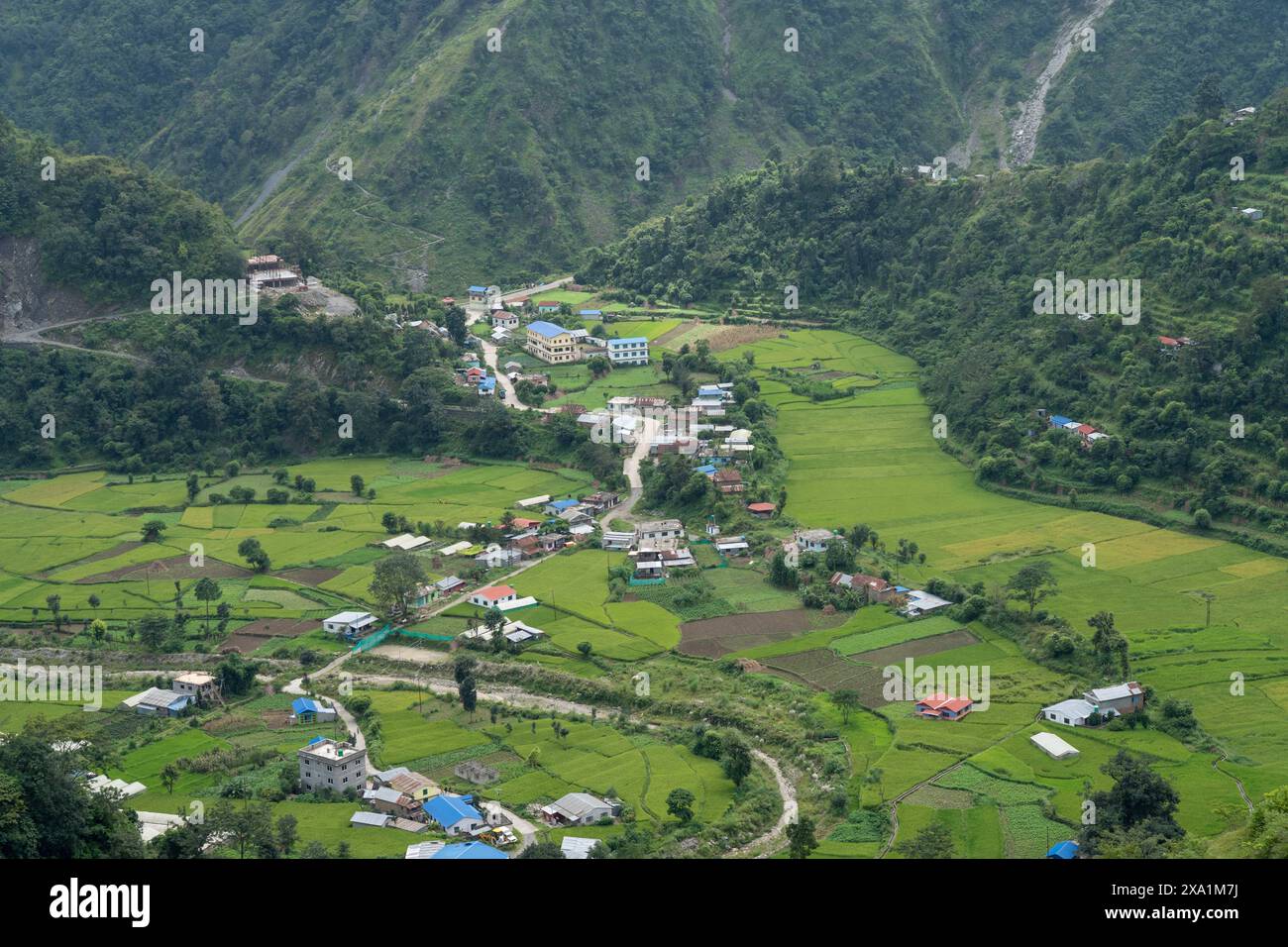 Nepal Rural Valley A valley with village houses and numerous trees in the mountains of ...