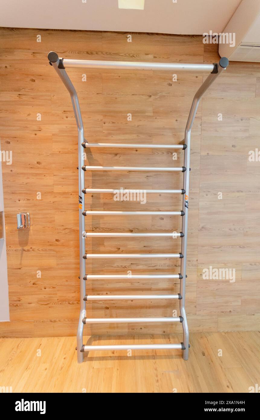 Ladder hanging on wooden wall with wood floor Stock Photo