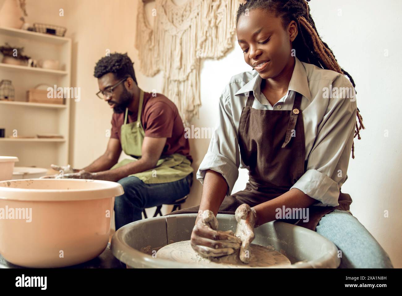 Pottery. Man and woman having a pottery workshop and looking involved Stock Photo