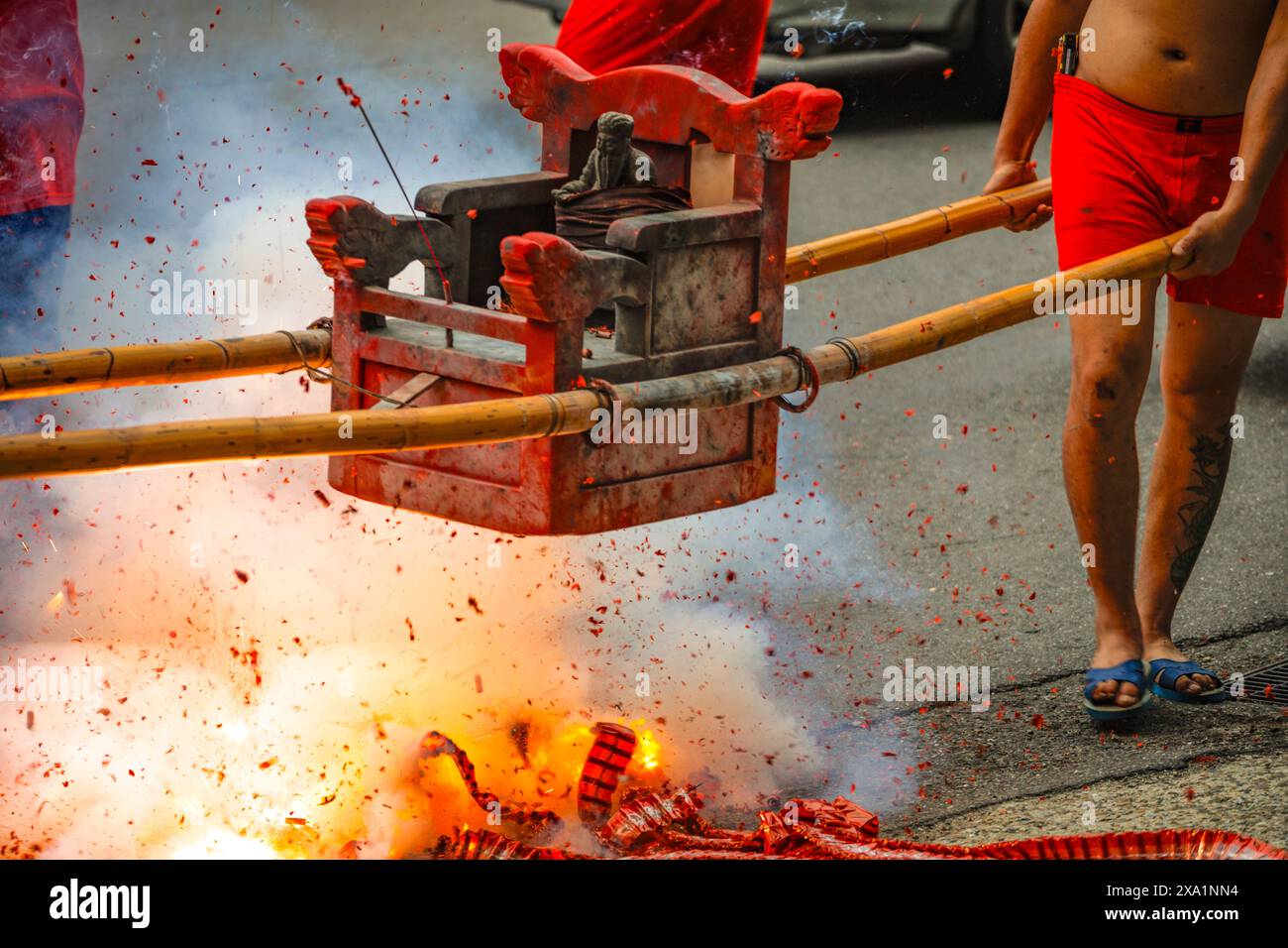 A man extinguishing a flaming hydrant with a hydraulic tool Stock Photo
