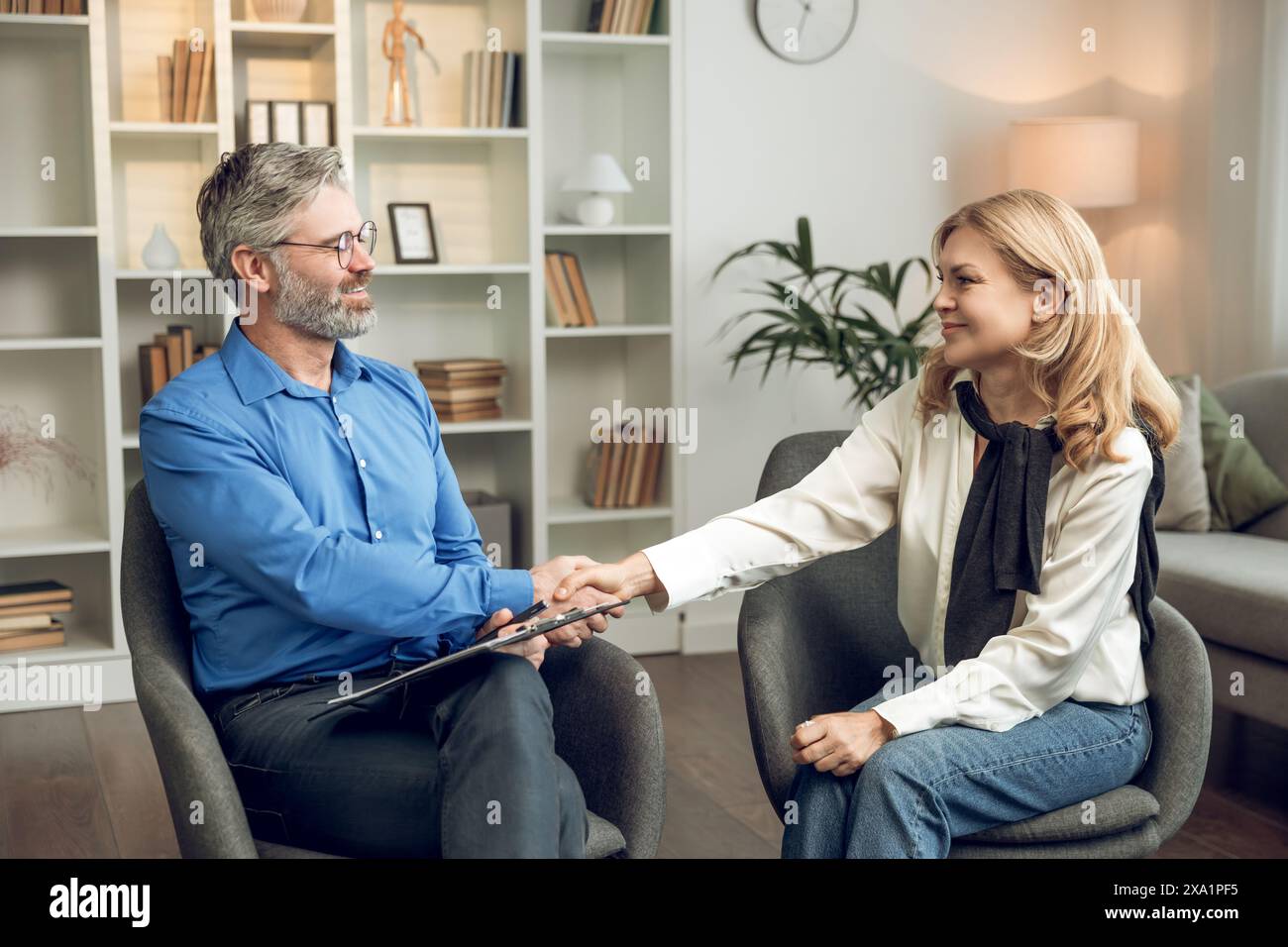 Visit to psychologist. Woman talking to psychotherapist solving mental health problems in medical clinic Stock Photo