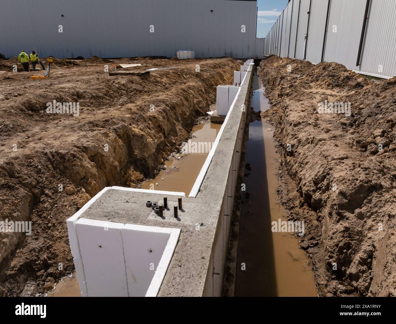 The workers building at  at an industrial construction site Stock Photo