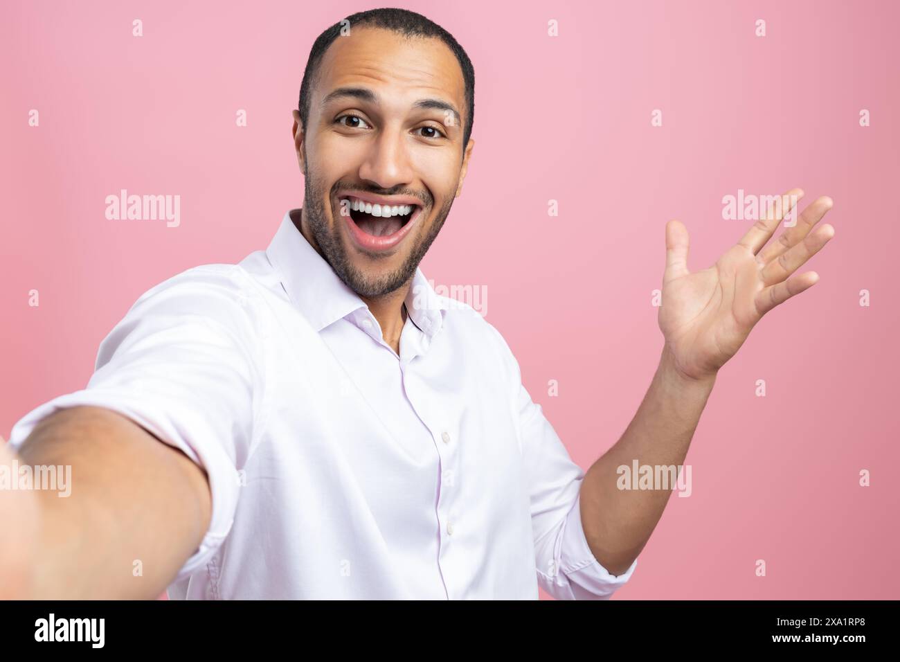Handsome man in white shirt making point of view photo isolated over pink background Stock Photo