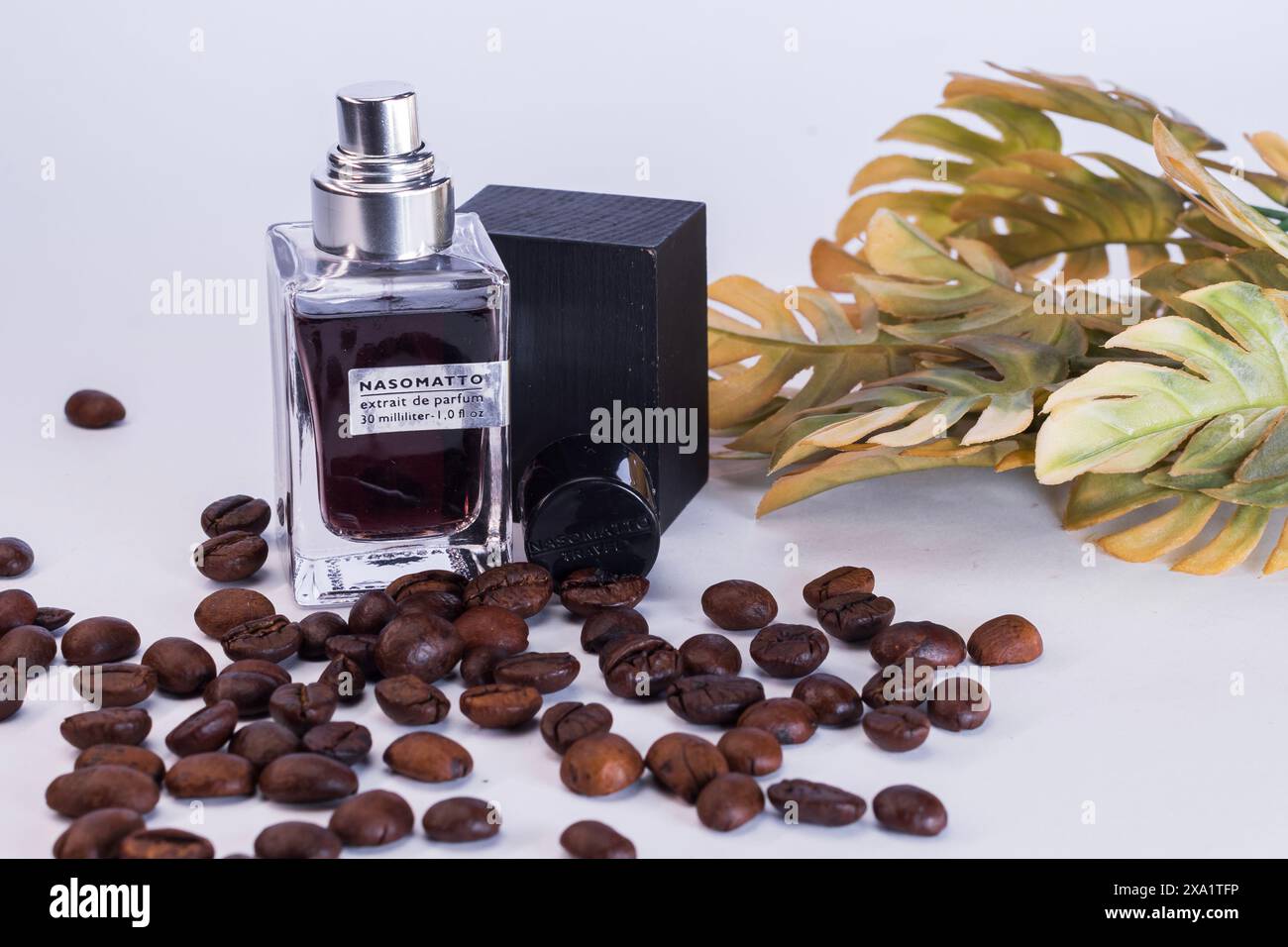 Coffee beans, perfume bottle, and a flower on display Stock Photo Alamy
