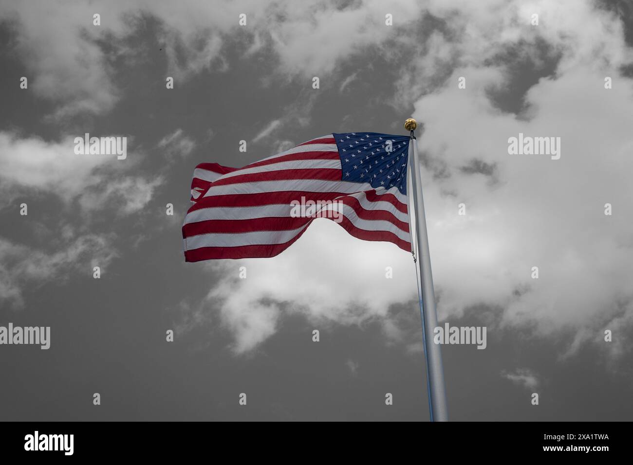 The American flag waving under a cloudy sky Stock Photo - Alamy