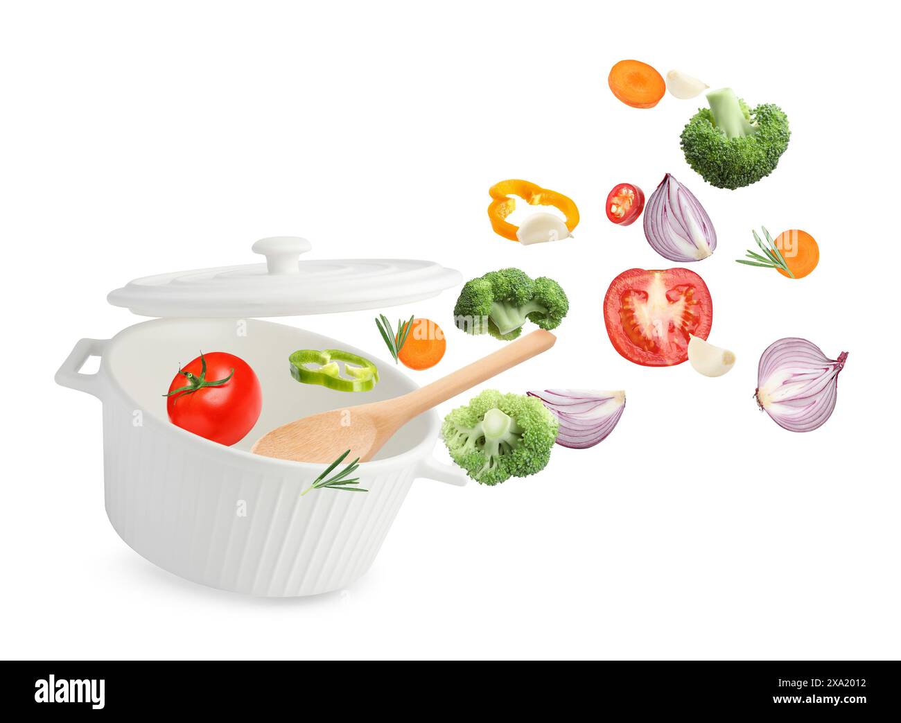 Fresh ingredients falling into saucepan on white background Stock Photo