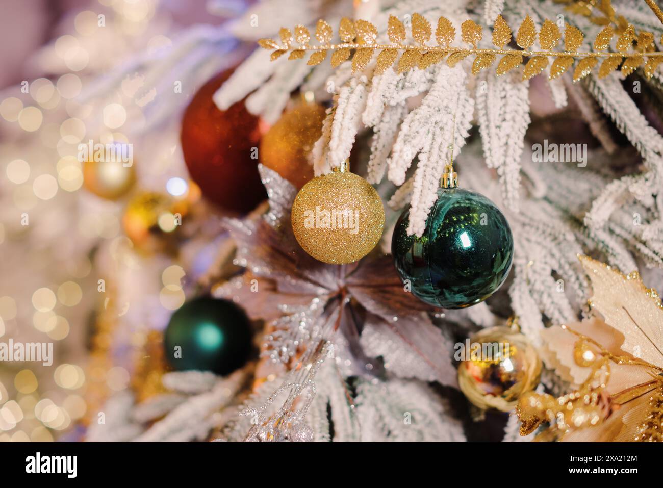 Festive ornaments adorn the base of a Christmas tree indoors Stock ...