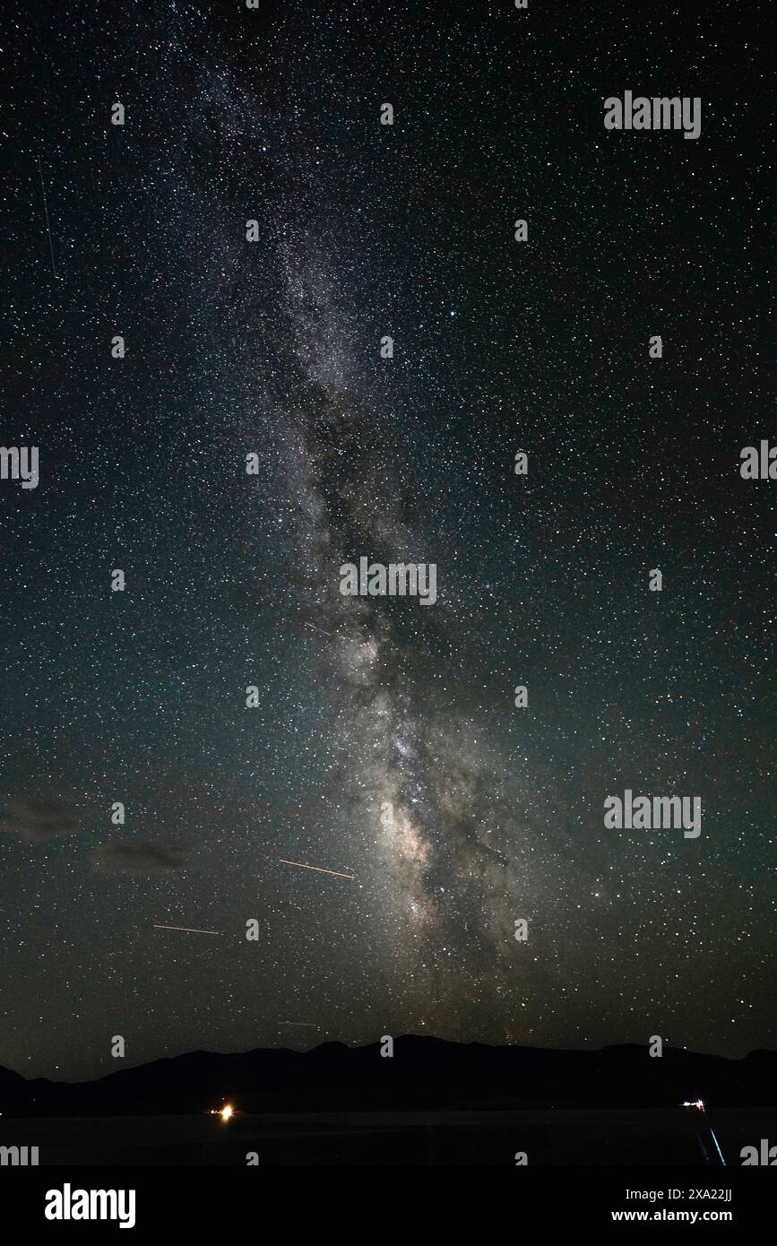 A night sky with stars and the Milky Way in the background Stock Photo ...