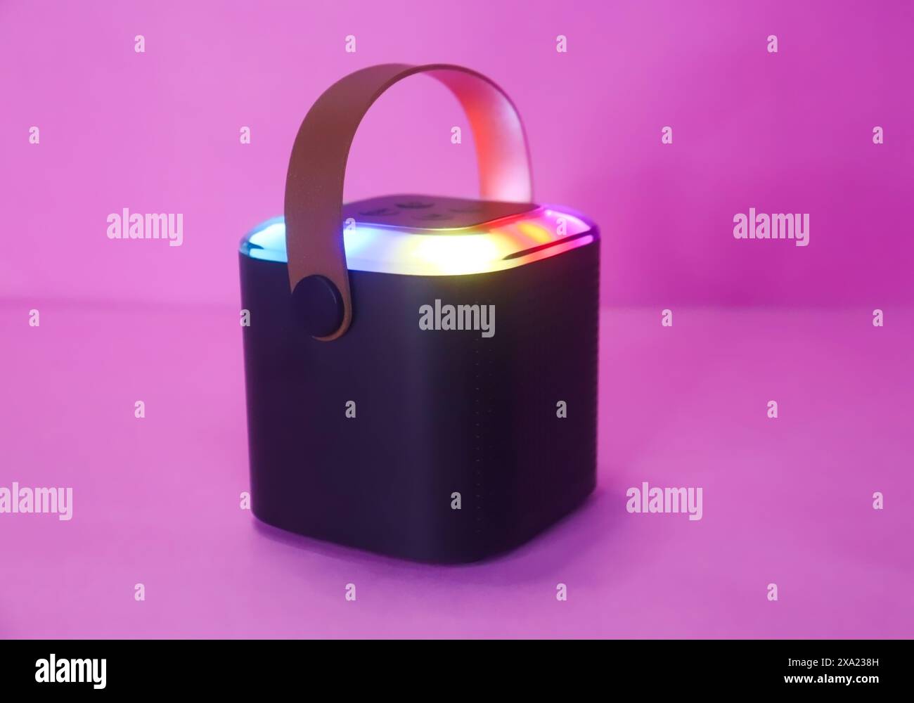 Hanging Bluetooth Speaker On The Pink Surface, Mini Speaker With Lights Stock Photo