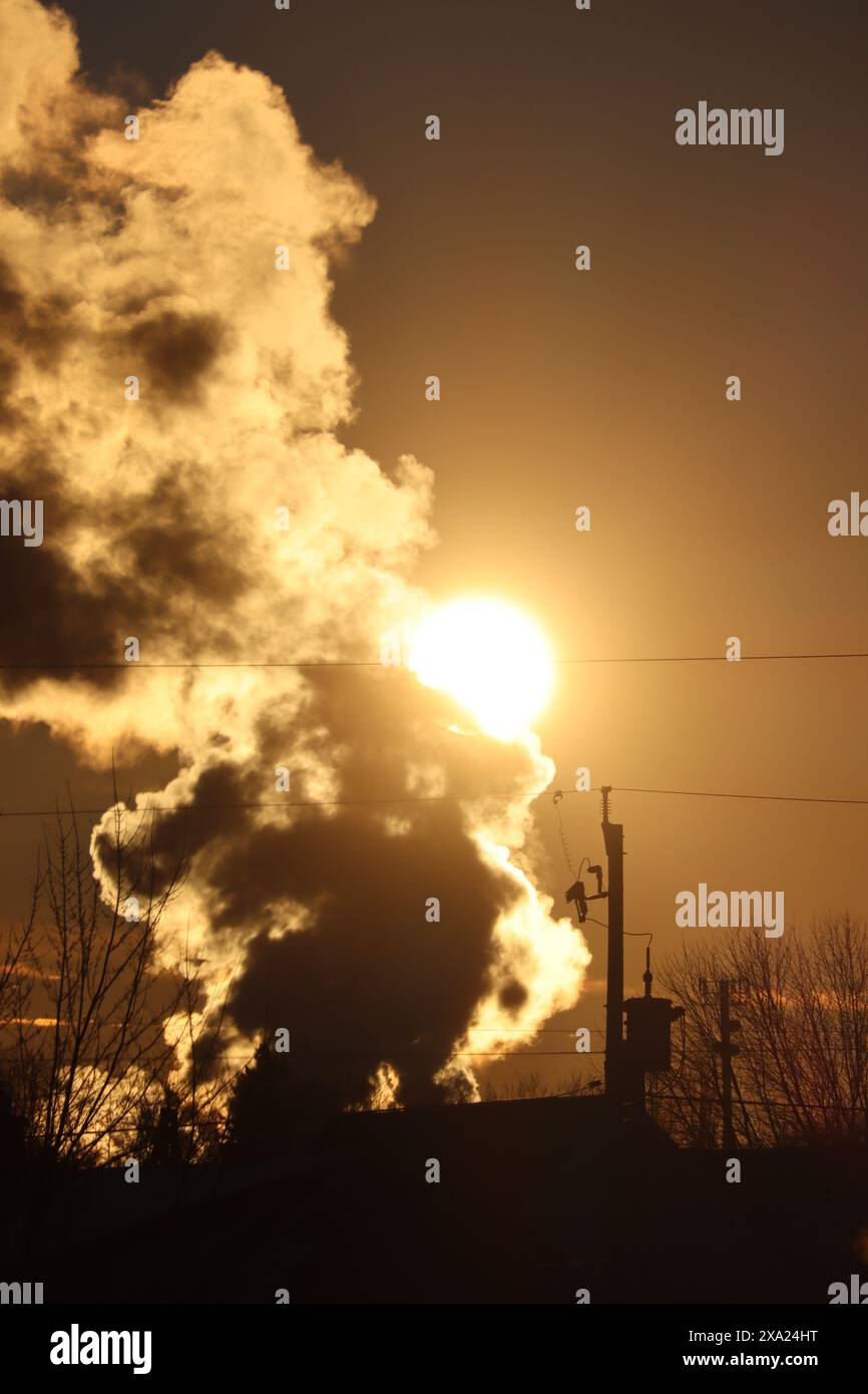 A sunset against smoke clouds from power plant Stock Photo - Alamy