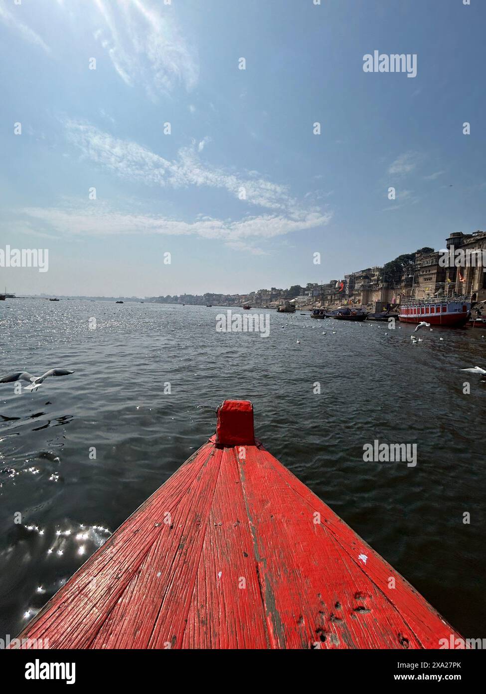 A red boat floating on calm waters Stock Photo