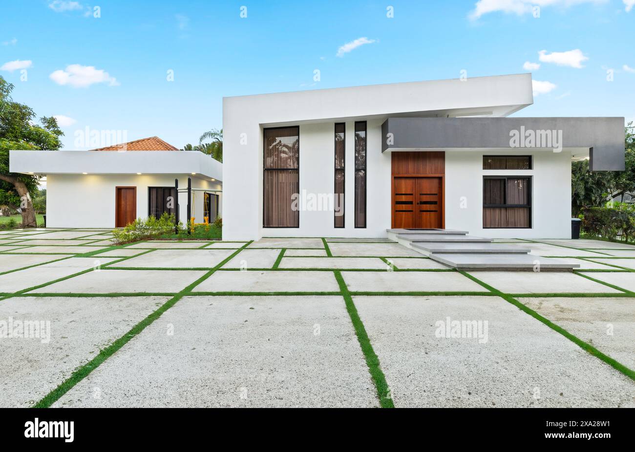 A contemporary white house facade with front garden and entrance
