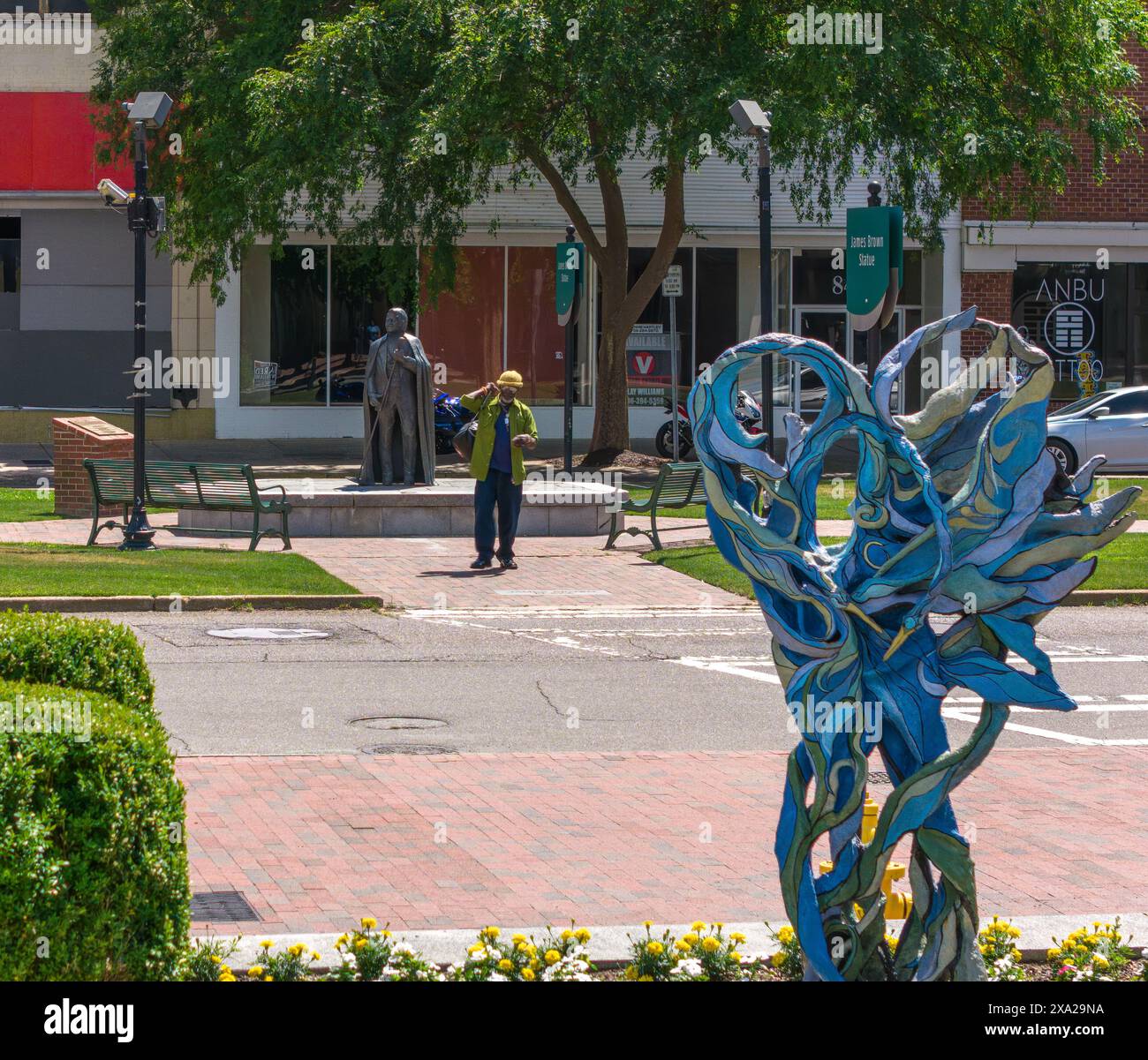 A blue sculpture on brick sidewalk by water in Downtown Augusta, Georgia Stock Photo