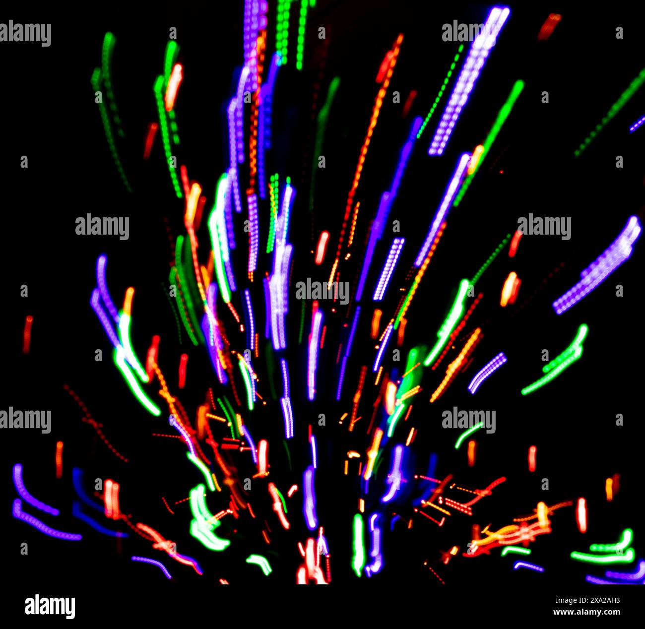 Colored lights with panning against a black background with a fire hydrant Stock Photo
