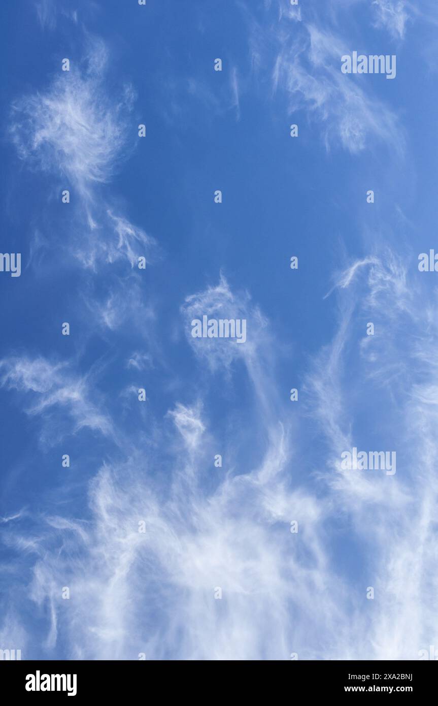 The fluffy clouds in a clear blue sky Stock Photo