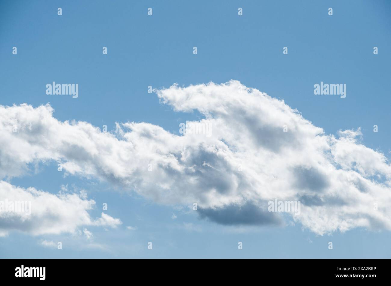 The fluffy clouds in a clear blue sky Stock Photo - Alamy