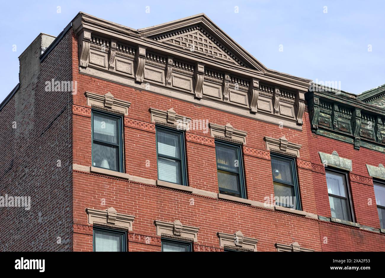 jersey city brownstone building detail (historic pre-war red brick buildings with power lines) beautiful real estate apartment homes with cornice deco Stock Photo