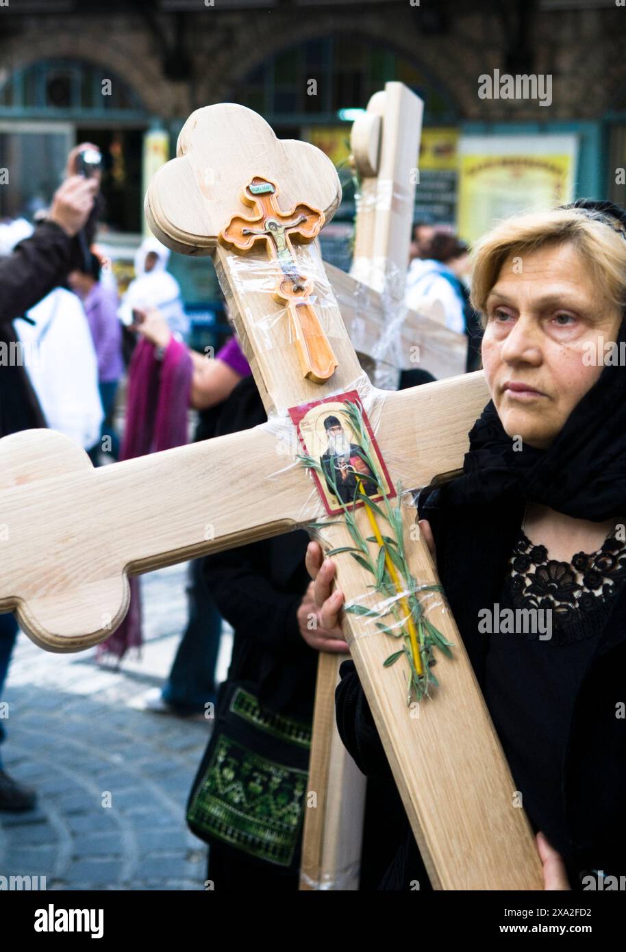 A Serbian pilgrim carrying the cross during the Good Friday procession ...