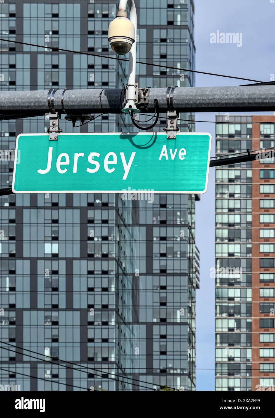 jersey avenue street sign on traffic intersection with tall modern