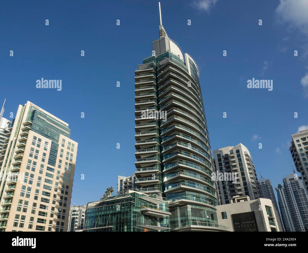 A modern high-rise building with a glass facade in an urban setting ...