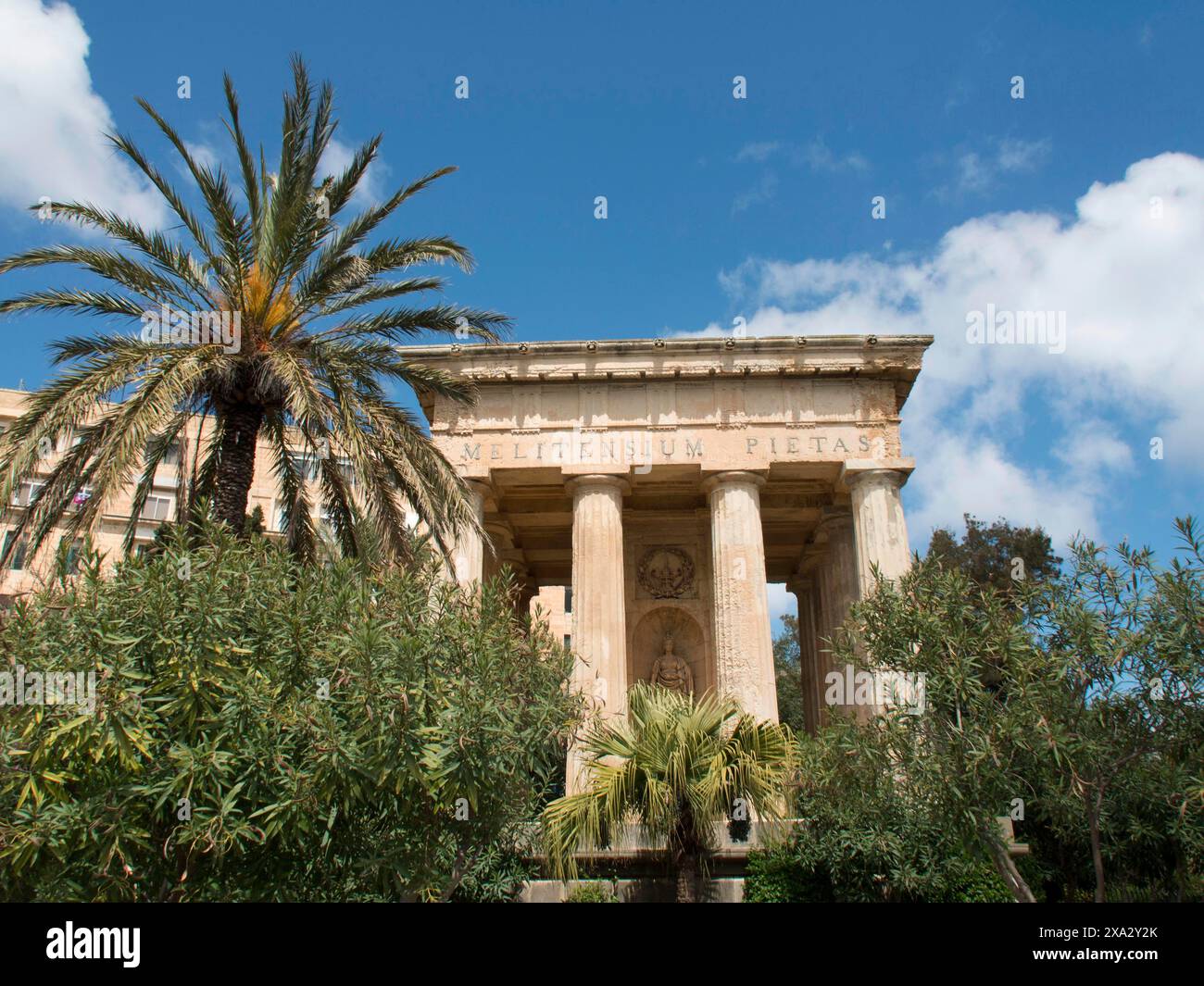 Ancient temple surrounded by palm trees and trees under a clear blue ...