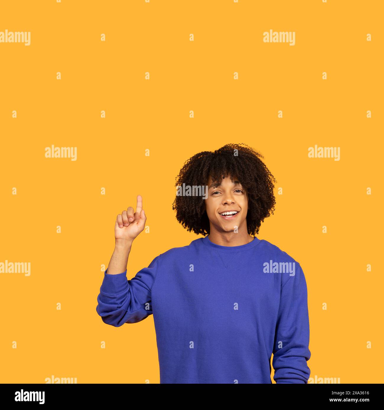 Man in Blue Shirt Holding Hand Up Stock Photo