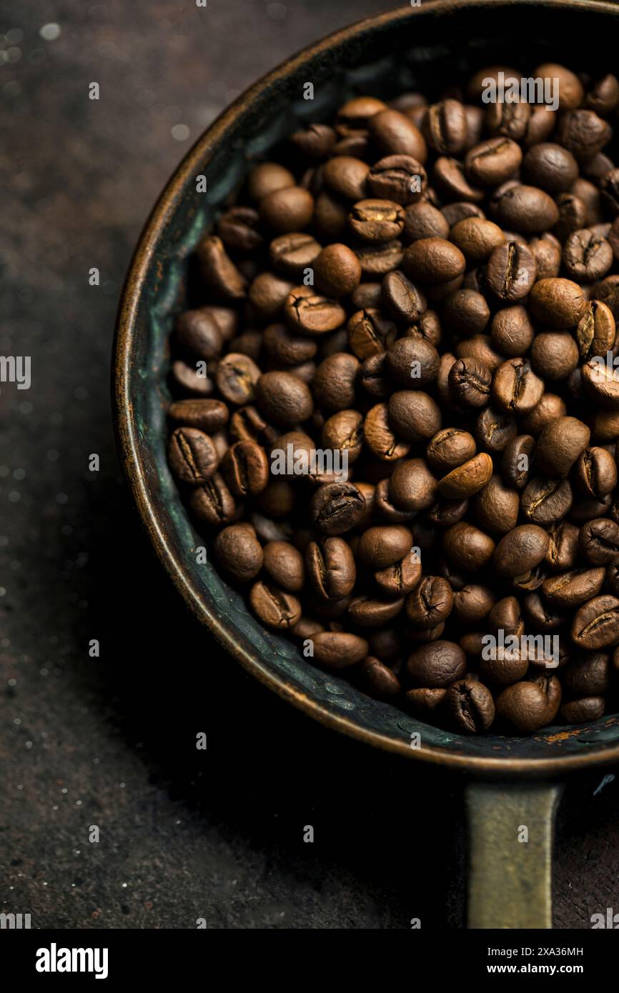 Whole roasted coffee beans in a rustic bowl Stock Photo - Alamy