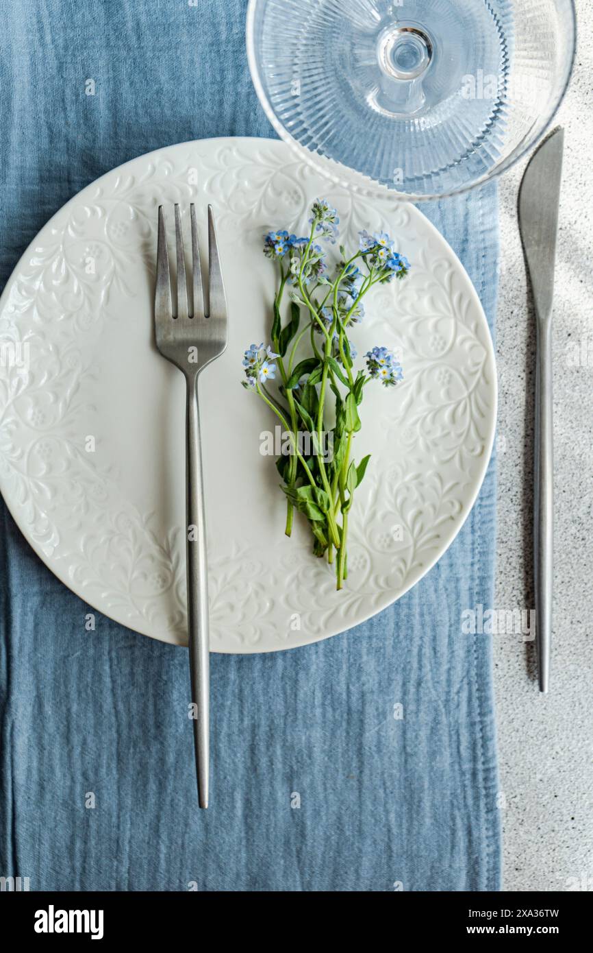 Spring table decoration with forget-me-not flowers Stock Photo