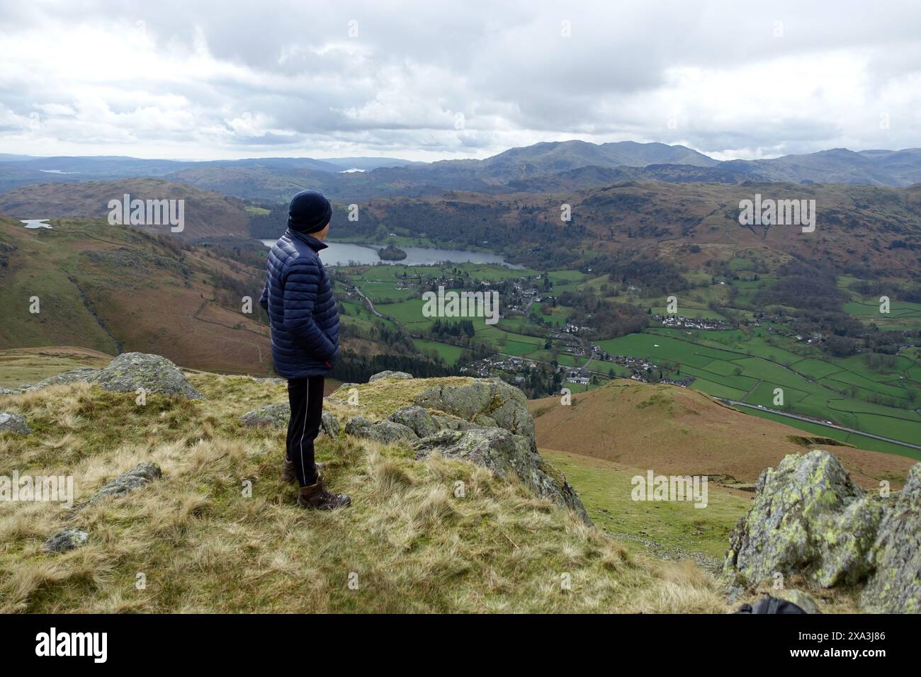 Man (Hiker) Standing on the Wainwright 'Stone Arthur' above Grasmere