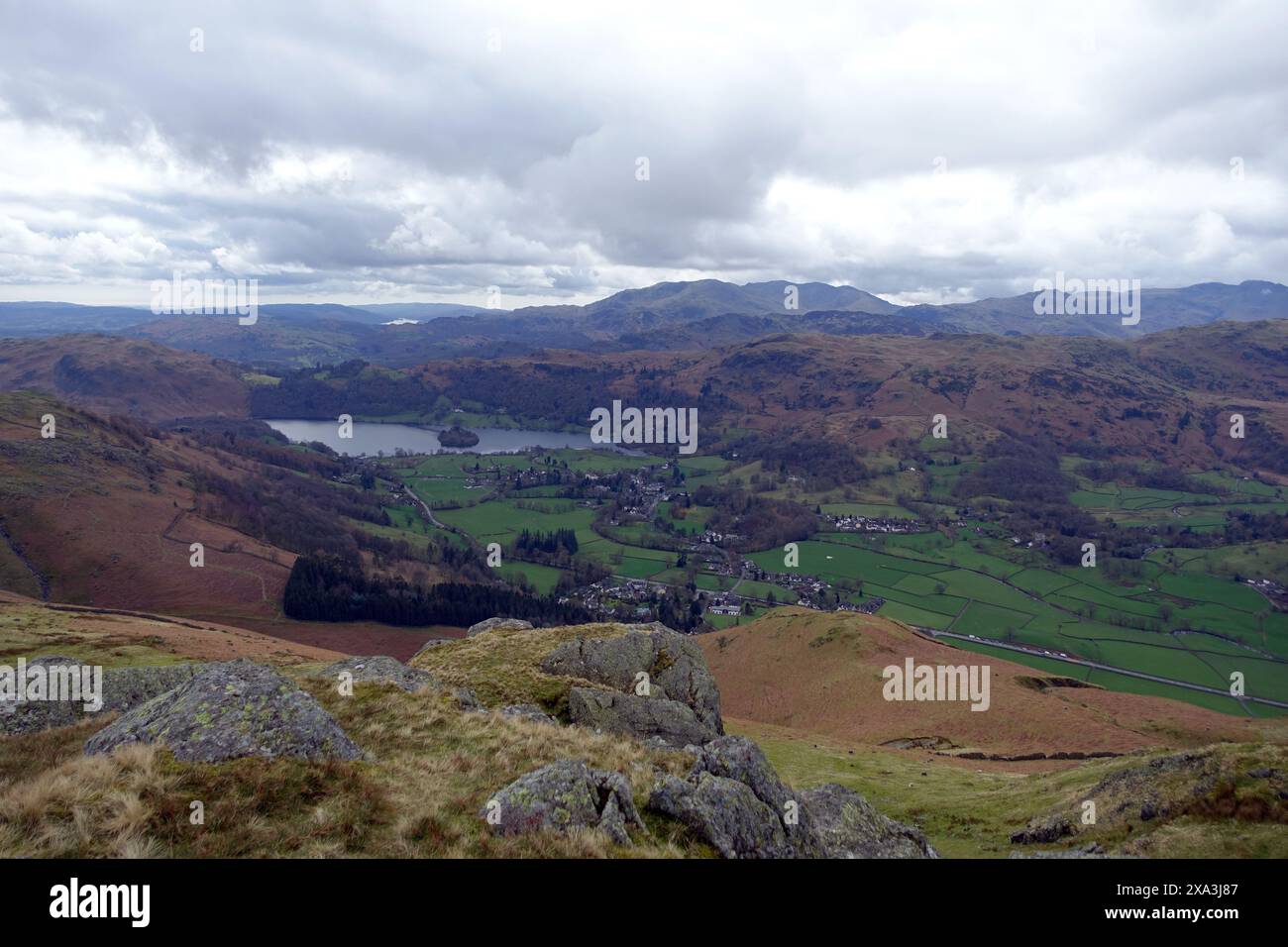 Grasmere Village & Grasmere Lake from the Crags on the Summit of the Wainwright 'Stone Arthur' in the Lake District National Park, Cumbria, England. Stock Photo