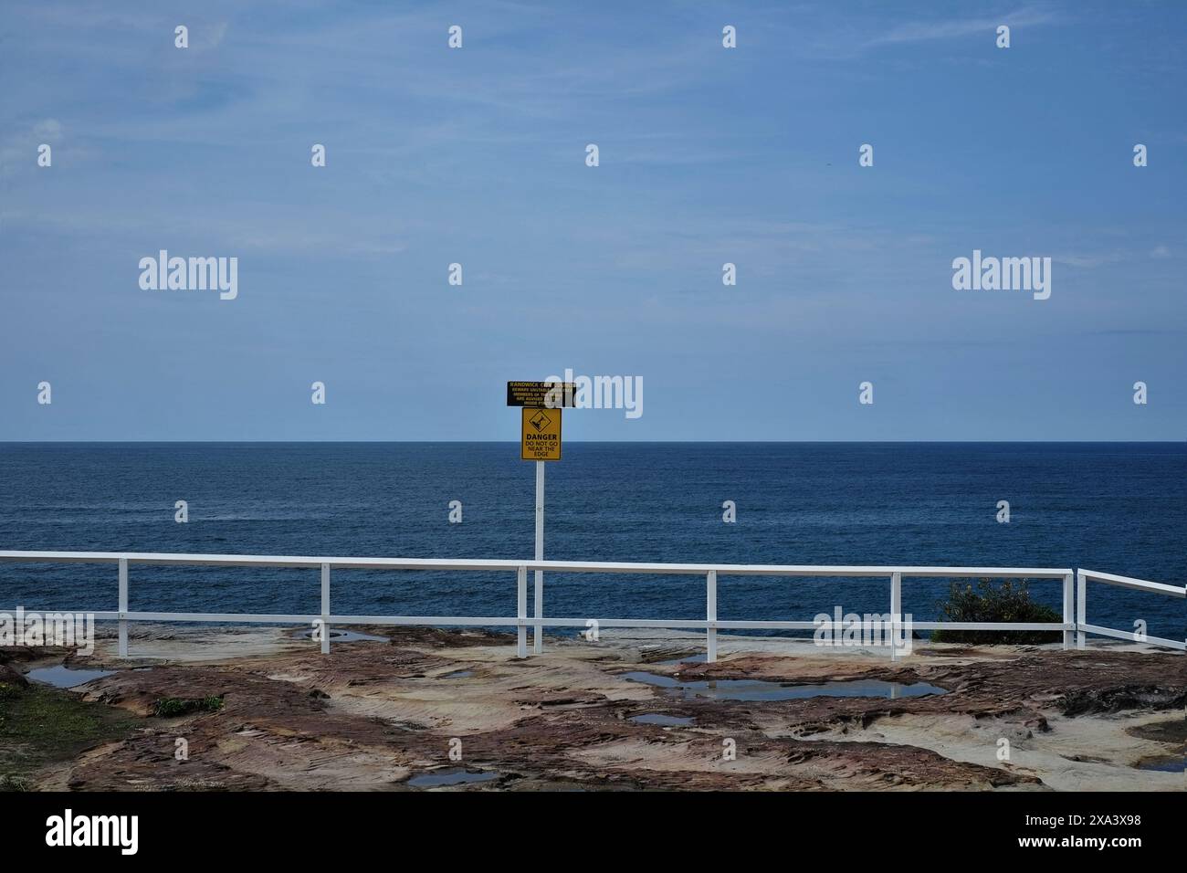 white wooden railings on the cliffs above Coogee bay, looking out towards the ocean, Sydney, Australia Stock Photo