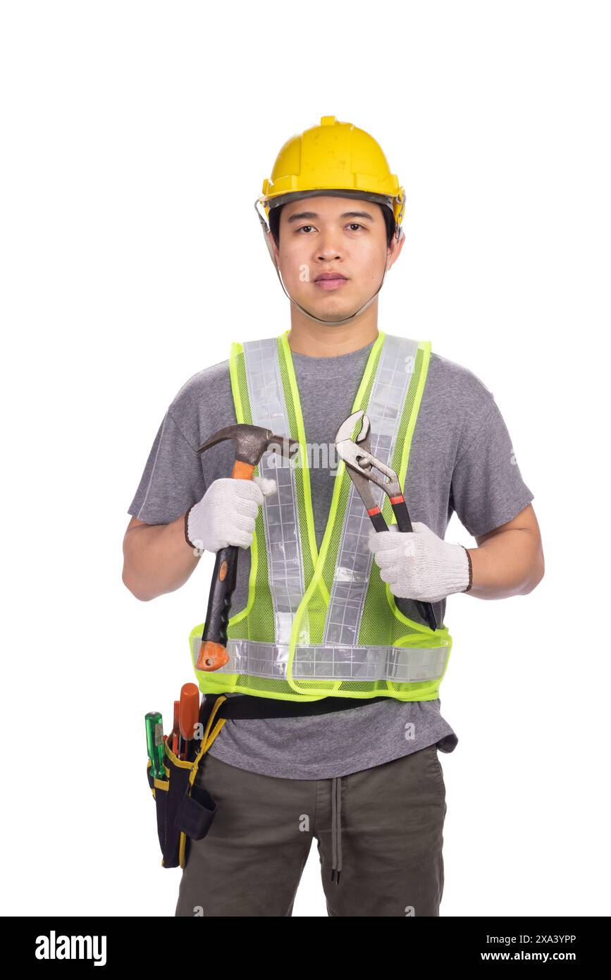 Asian male plumber holding pipe wrench standing on white background. Stock Photo