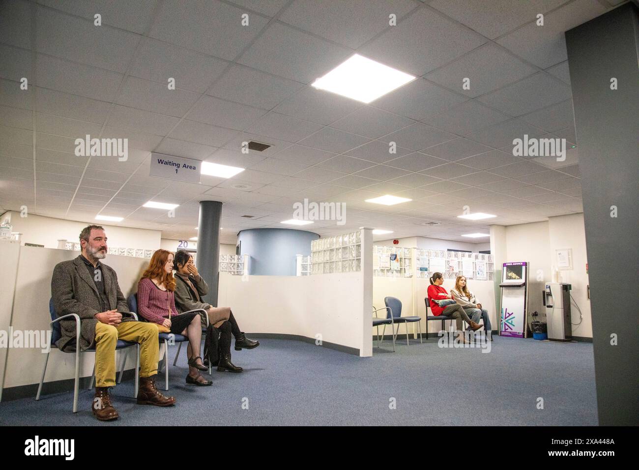 People waiting in a bright waiting area of a medical practice Stock Photo