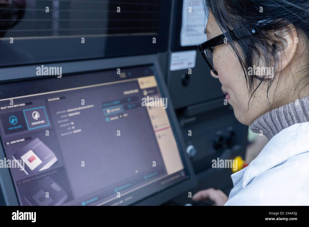 Woman using a touchscreen panel in a medical practice Stock Photo