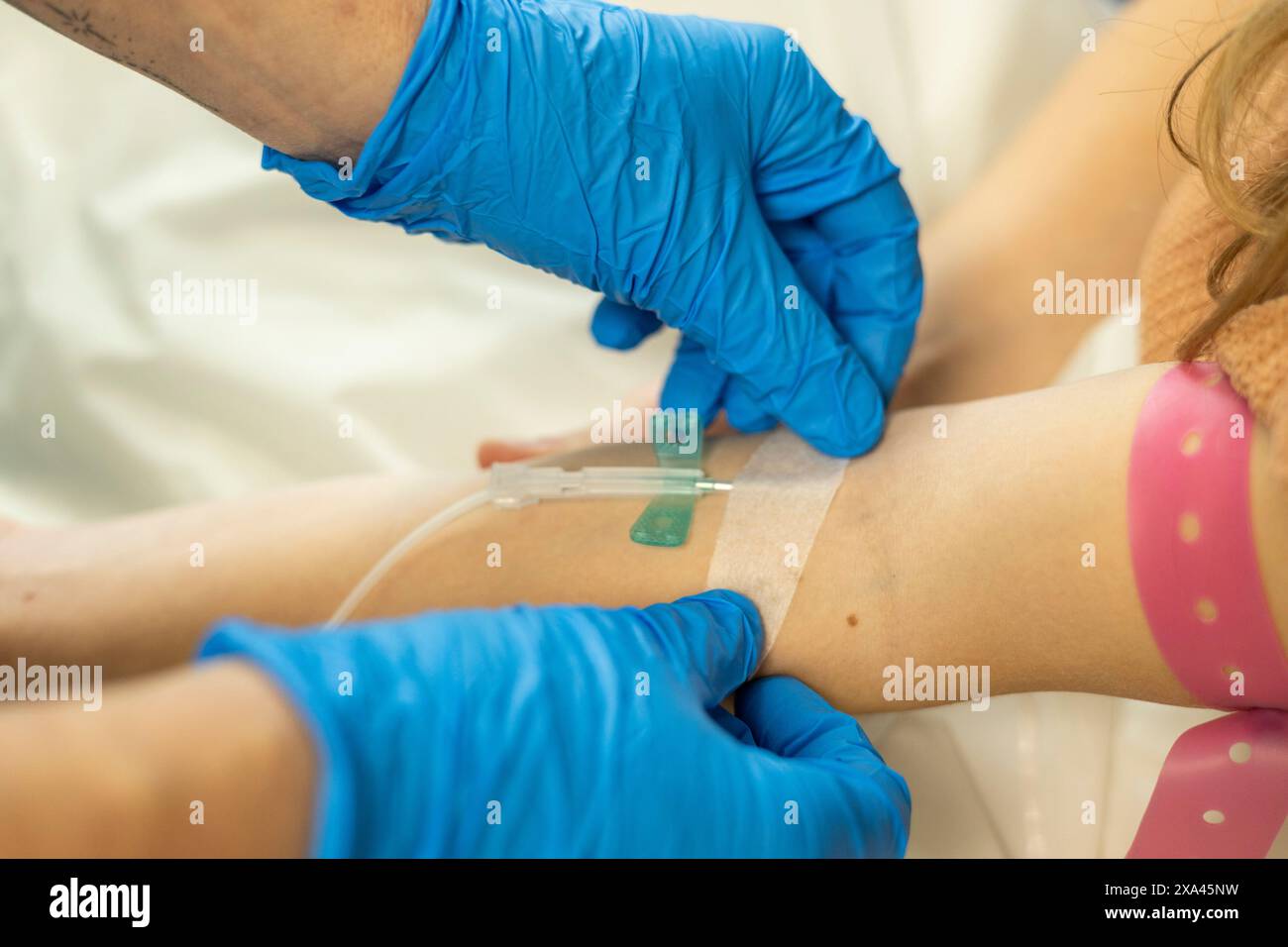 Medical professional inserting an iv catheter into a patient s arm