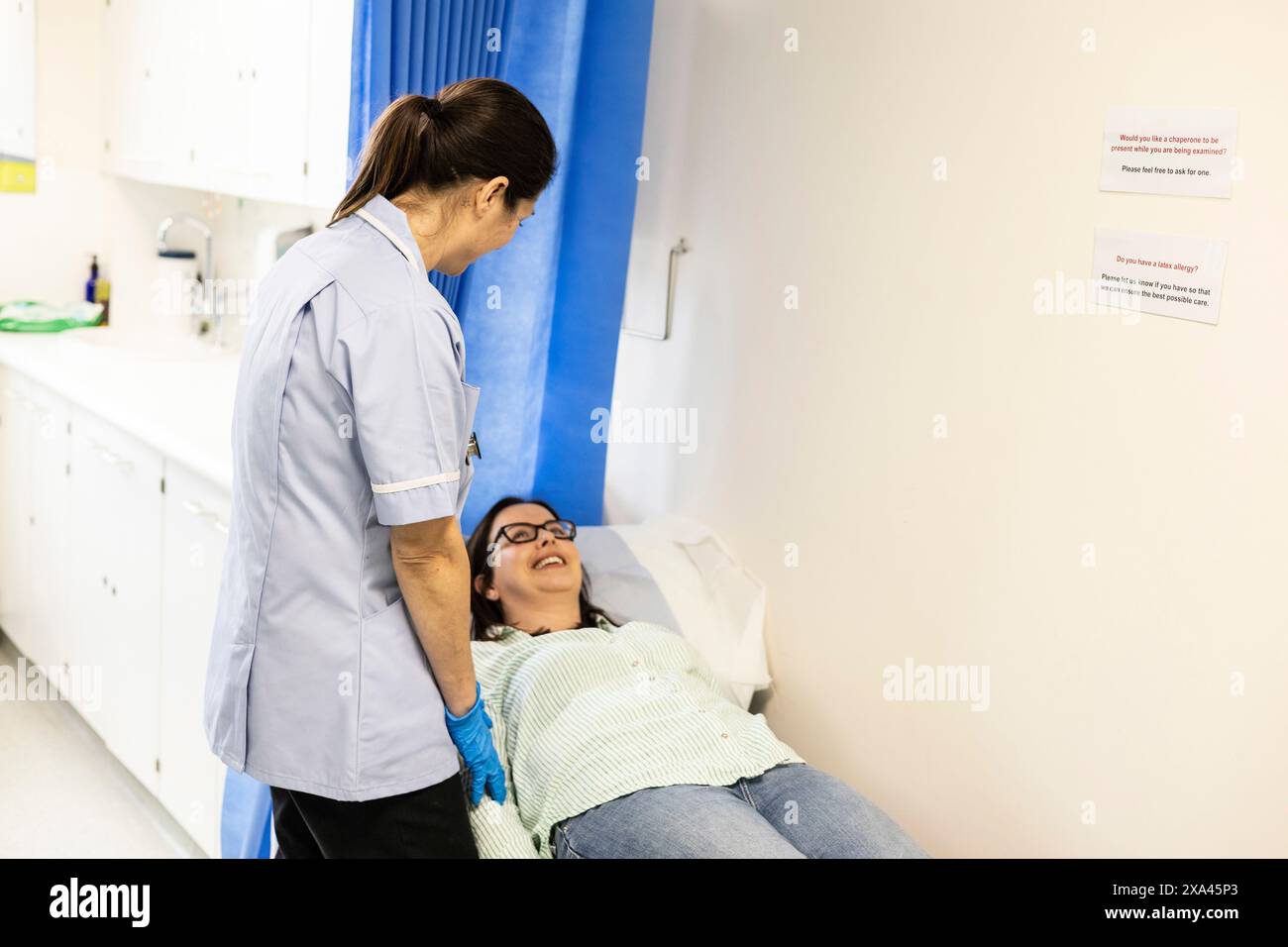 Nurse attending to a patient in a clinic Stock Photo