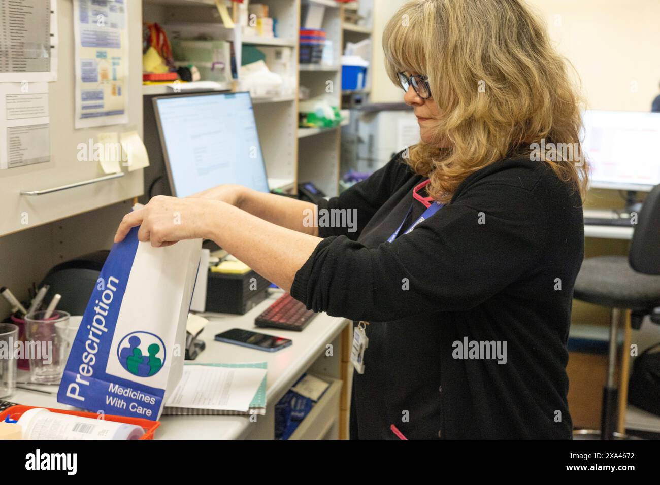 Pharmacist organizing prescription medicines at work. Stock Photo