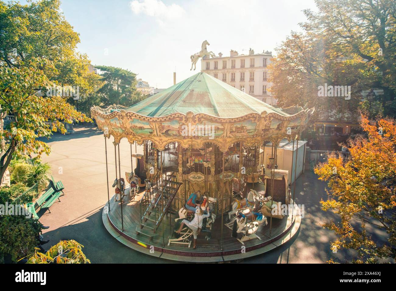 Sunlit vintage carousel in a tranquil park setting. Stock Photo