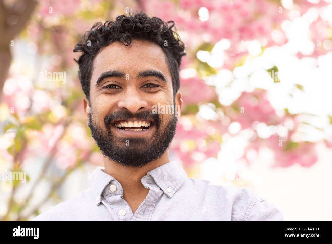Man with curly hair and beard hi-res stock photography and images - Alamy