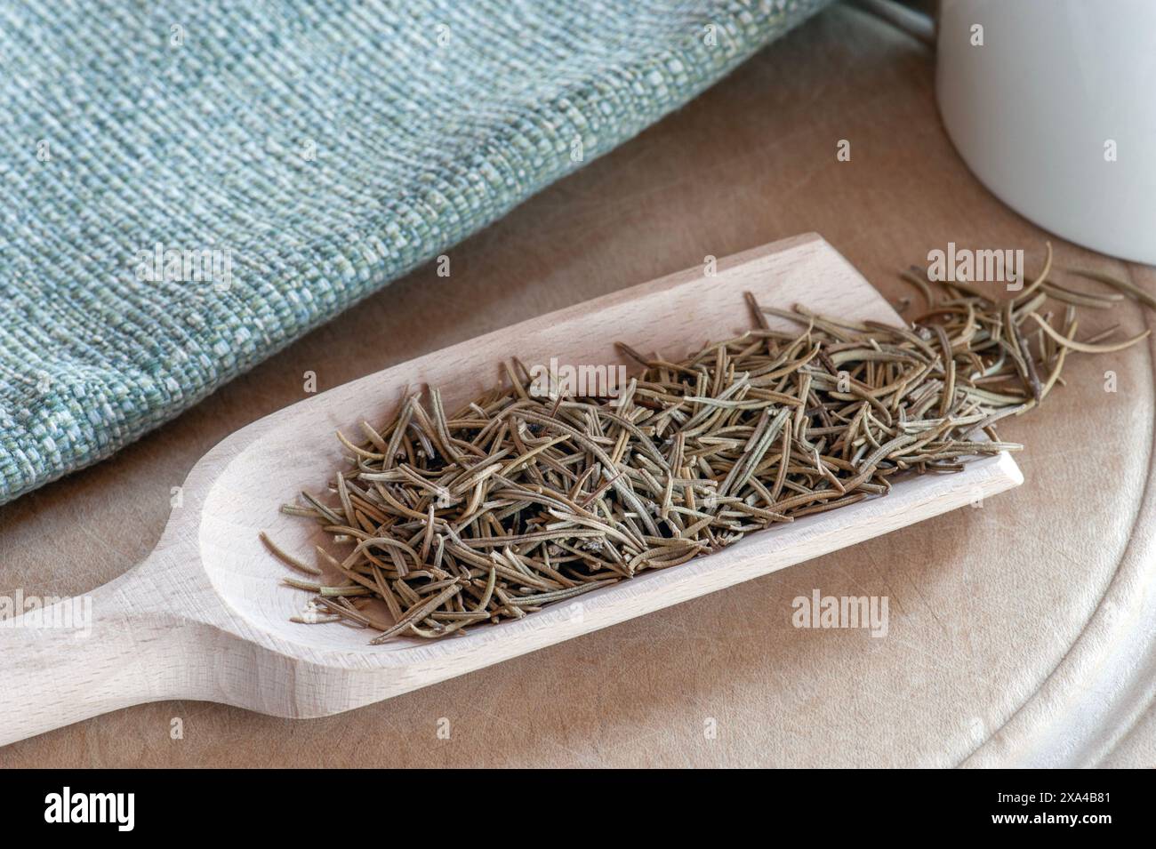 Scoop of Dried Rosemary. A popular aromatic herb used for culinary and medicinal purposes. Stock Photo