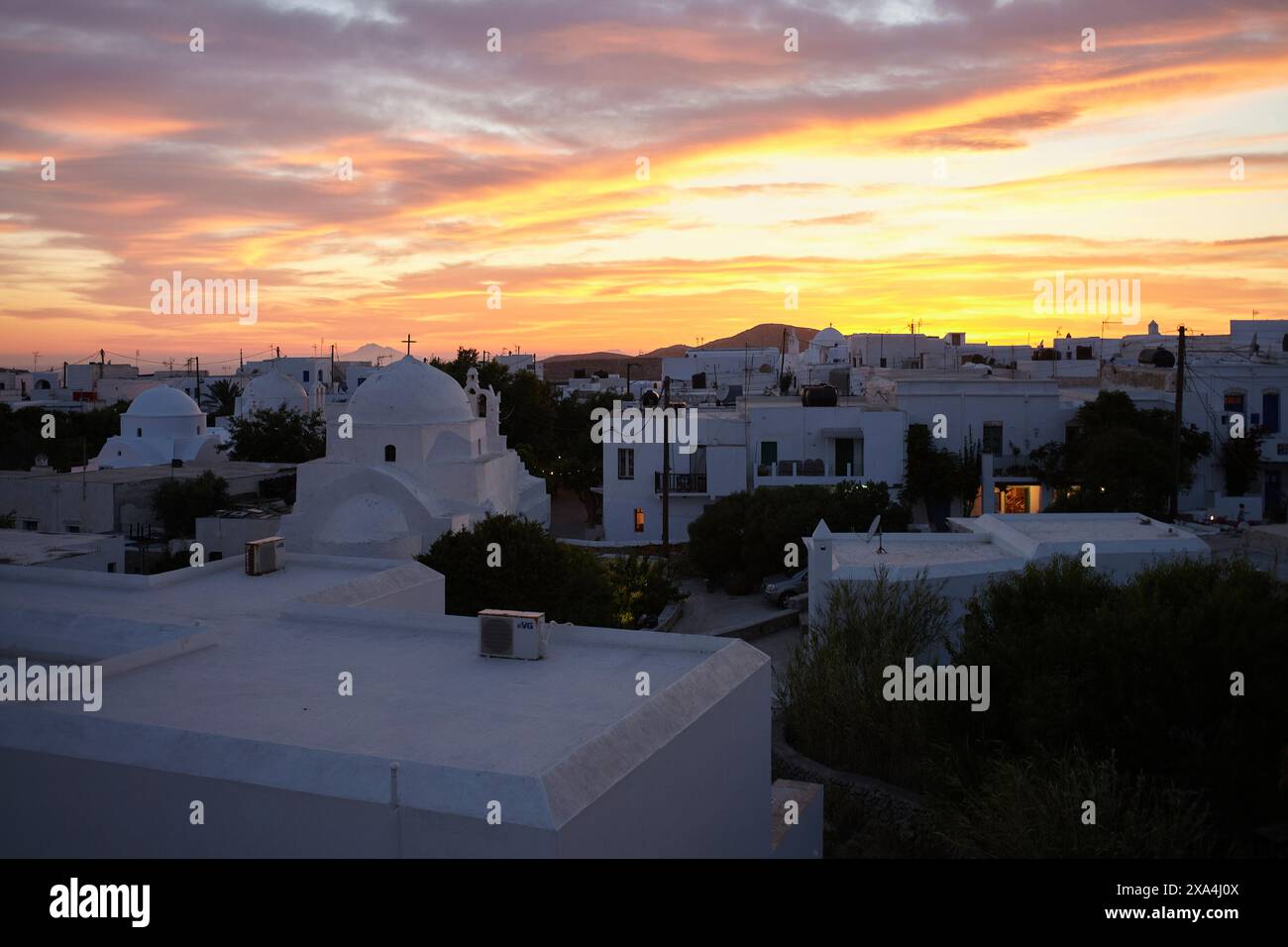 Sunset over a serene town with buildings displaying the iconic ...