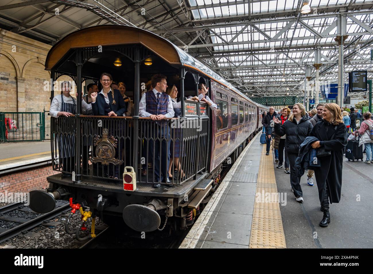 Passengers saying goodbye to staff in The Royal Scotsman luxury train observation car, Waverley Railway Station platform, Edinburgh, Scotland, UK Stock Photo