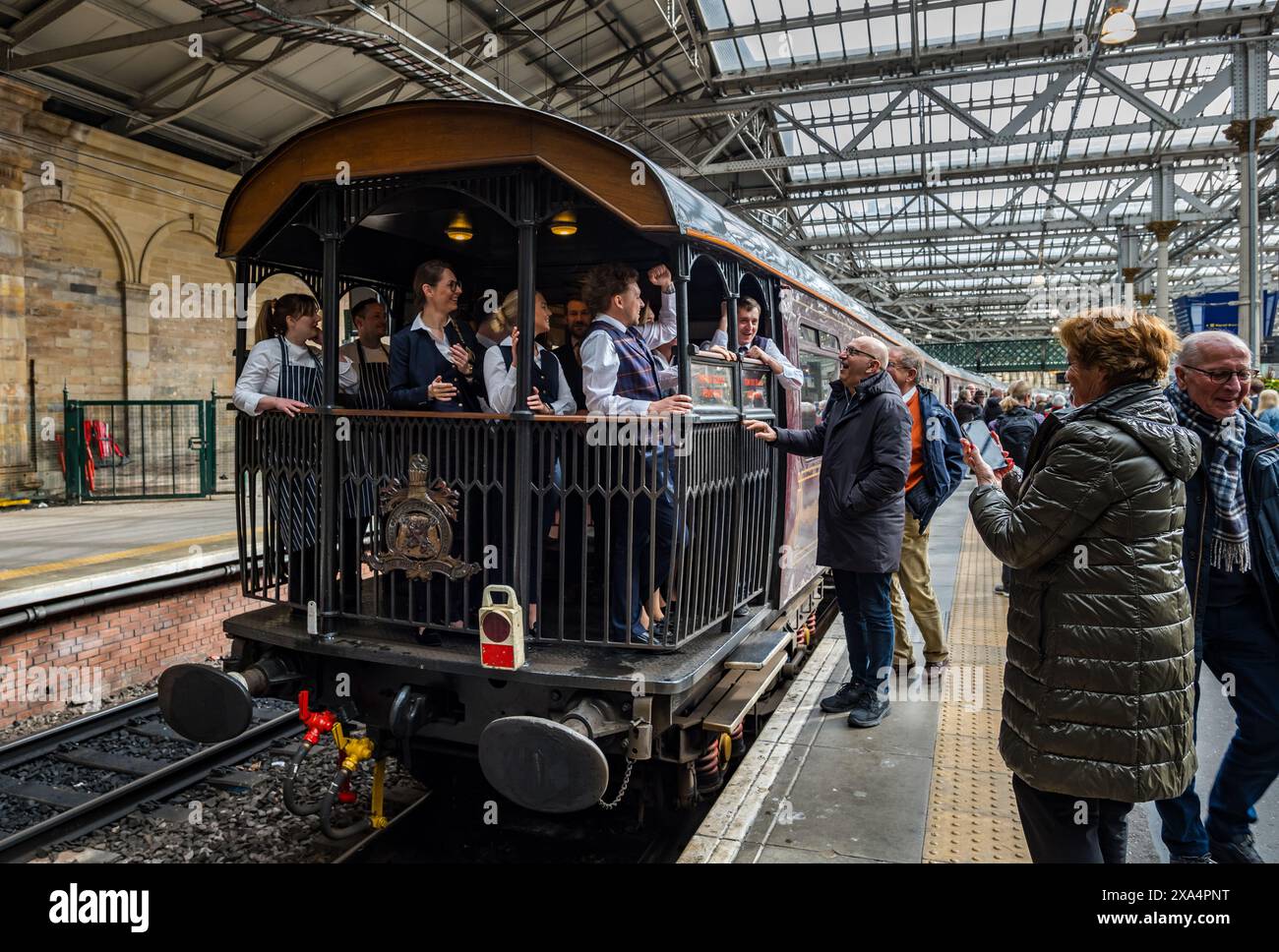 Passengers saying goodbye to staff in The Royal Scotsman luxury train observation car, Waverley Railway Station platform, Edinburgh, Scotland, UK Stock Photo