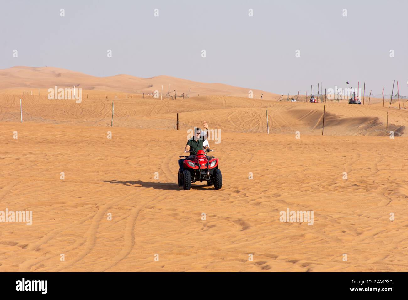 Dubai Atv Riding Tourist riding an ATV across expansive sandy terrain in the Dubai ...