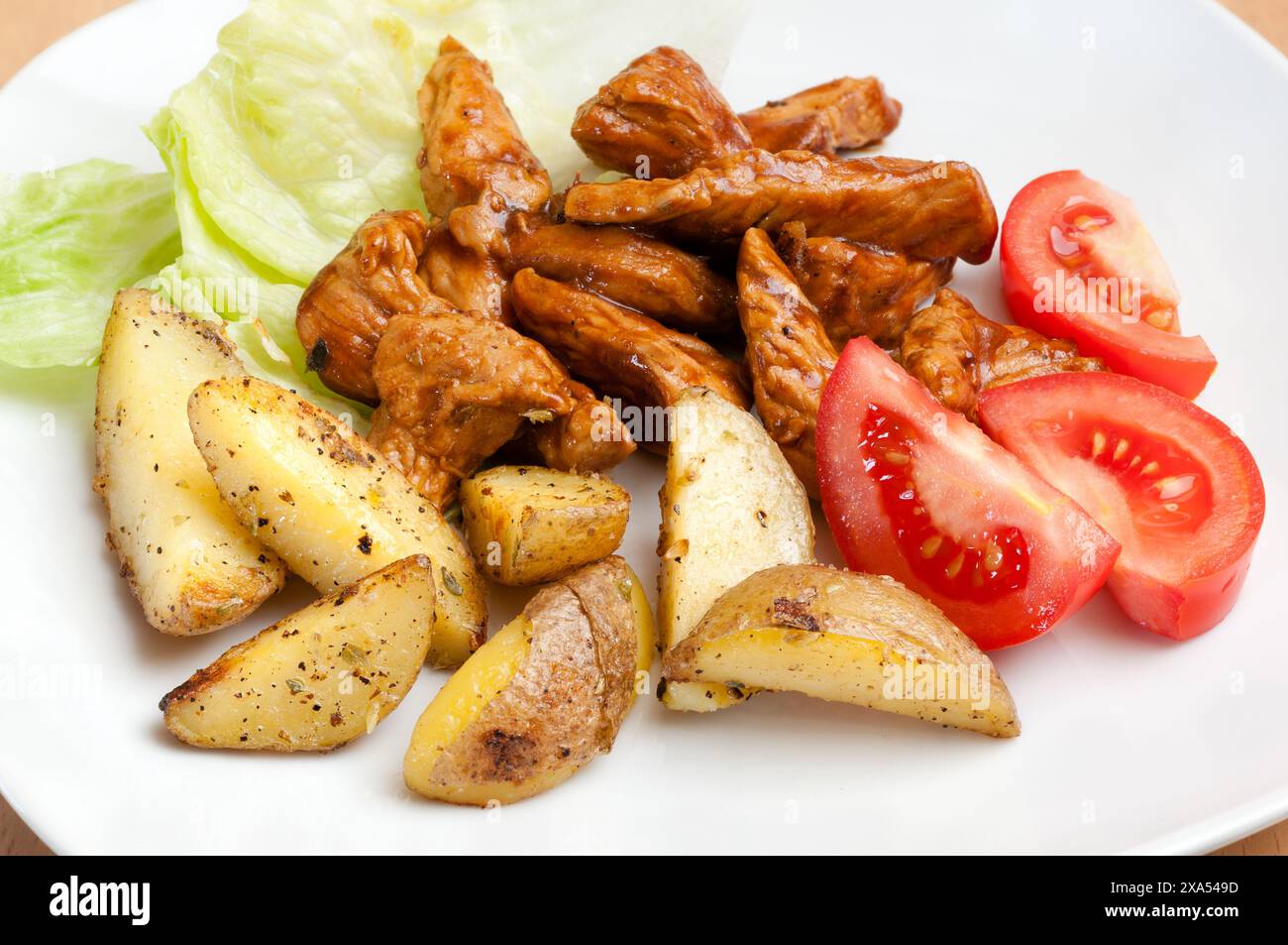 A plate of shredded turkey in cream sauce with potatoes Stock Photo