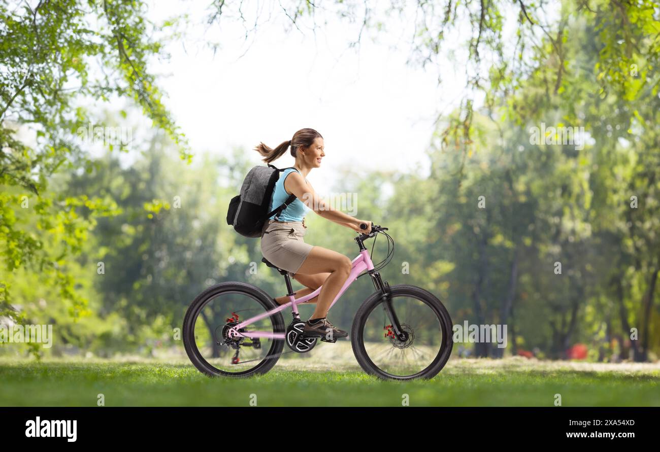 Backpack Riding Position Shot young woman riding bike hi-res stock photography and images - Alamy