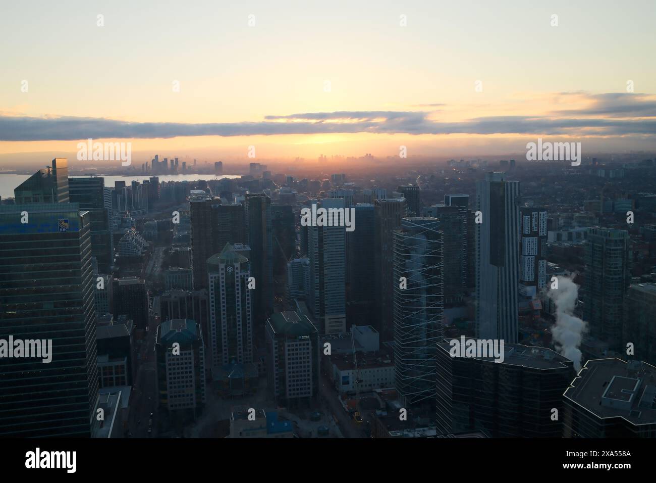 A city skyline at sunset with the sun appearing like it will illuminate ...