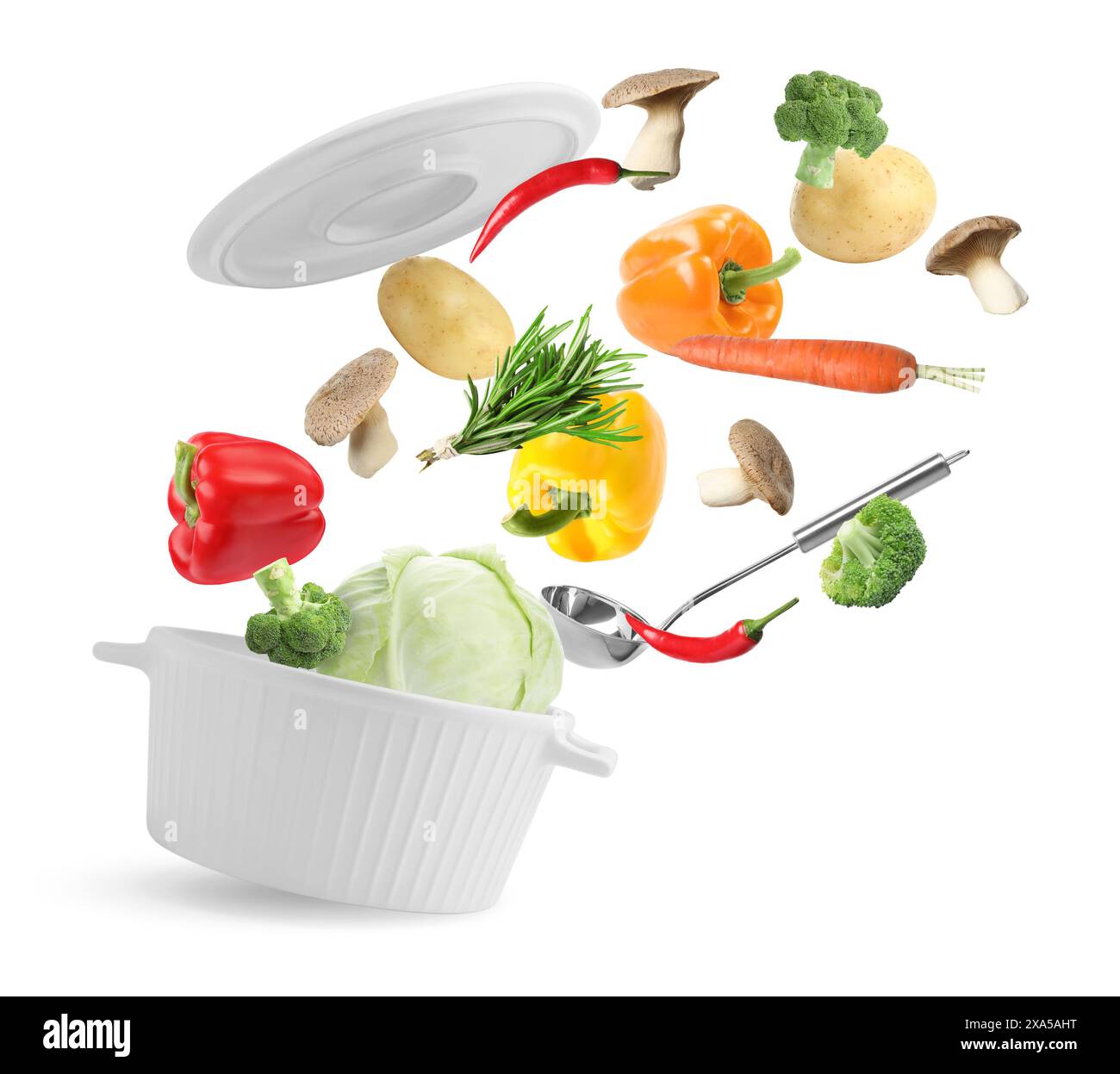 Fresh ingredients falling into saucepan on white background Stock Photo