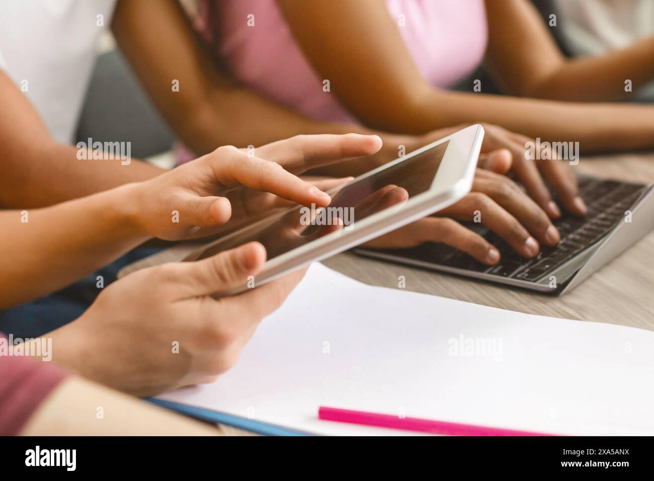 Student using tablet for studying, turning page Stock Photo