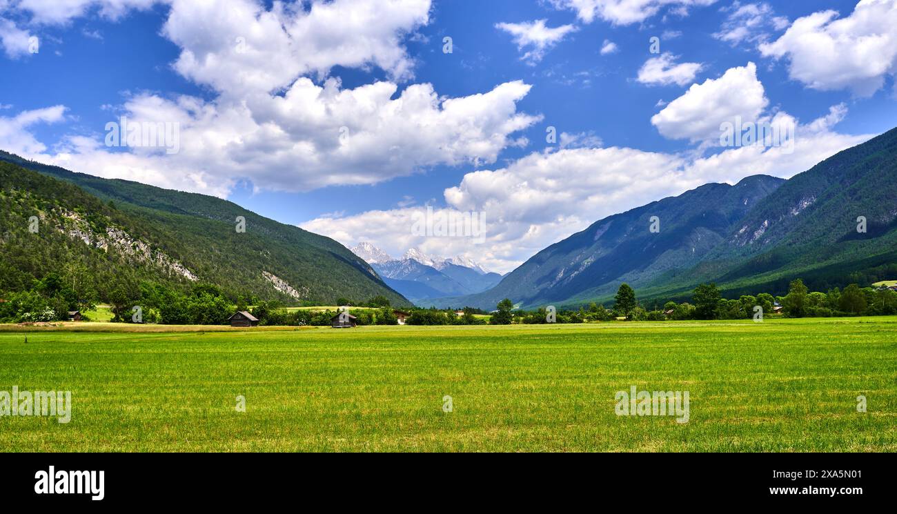 Mountain range in the distance, green field under cloudy sky Stock ...